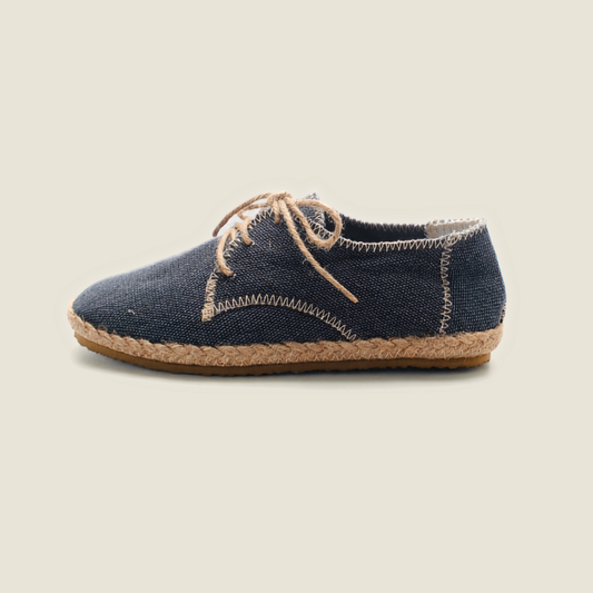 Black slip-on shoe with blue interior on a white background